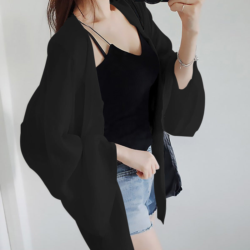Kvinnorsk elegant kimono jacka med en lös passform och intrikat designade ärmar-Eva Jonsson
