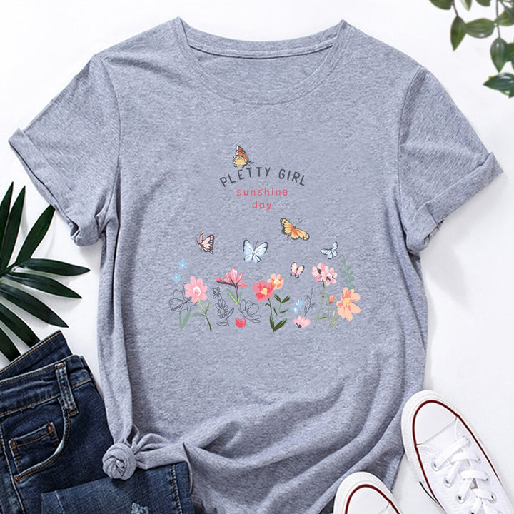 Kvinnot-shirt med lekfullt blommönster och elegant tryck Mirla-Eva Jonsson