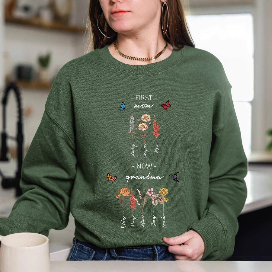 Kvinnotröja med blommig tryck och inspirerande text Mirla-Eva Jonsson