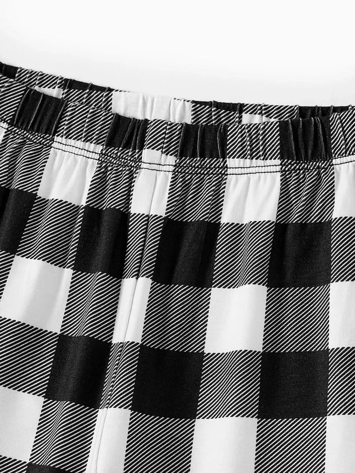 Mirla | Let It Snow Text And Snowman Print Black And White Checked Family Pajama-Eva Jonsson