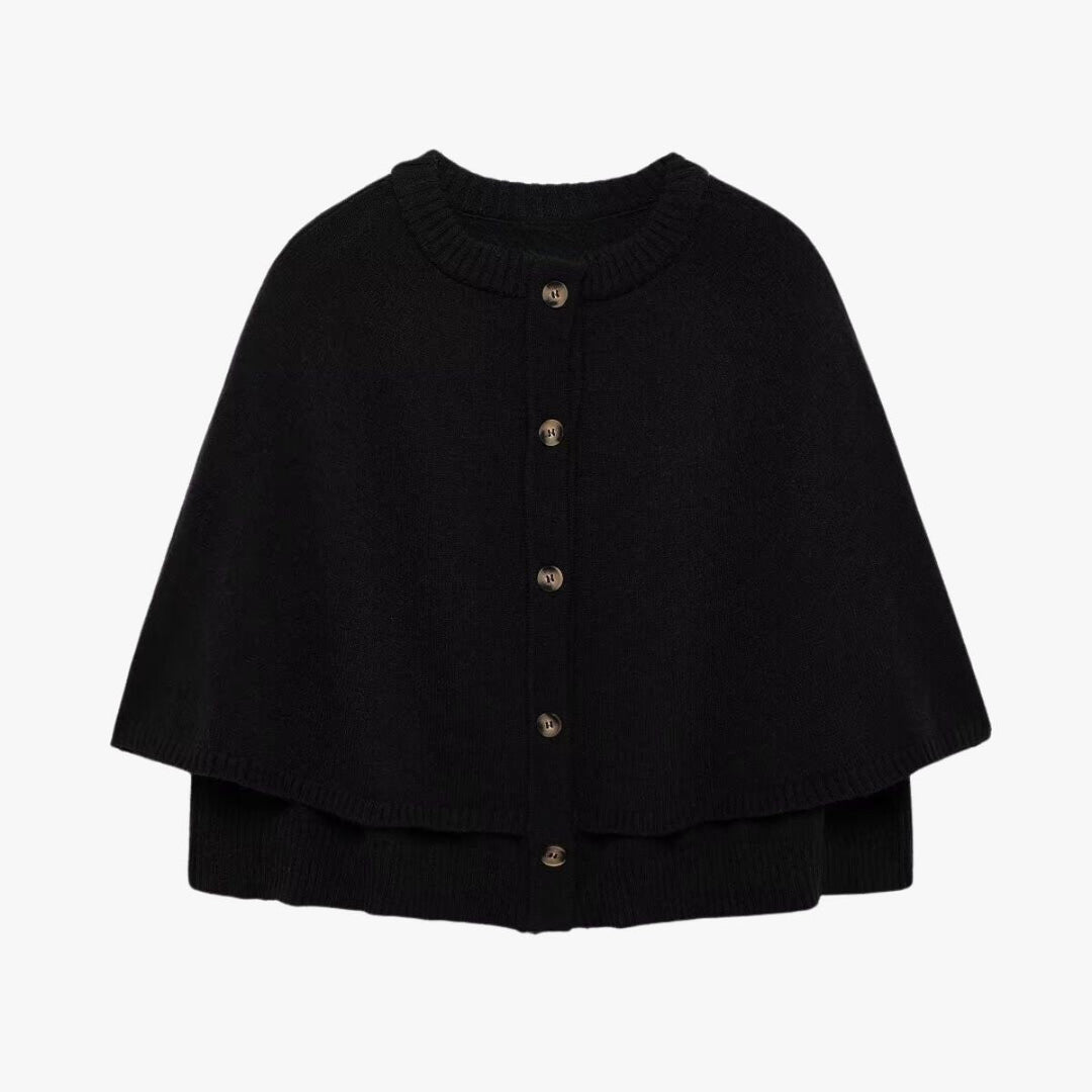 Mirla | Stickad cape med knappar och vågig fåll-Eva Jonsson